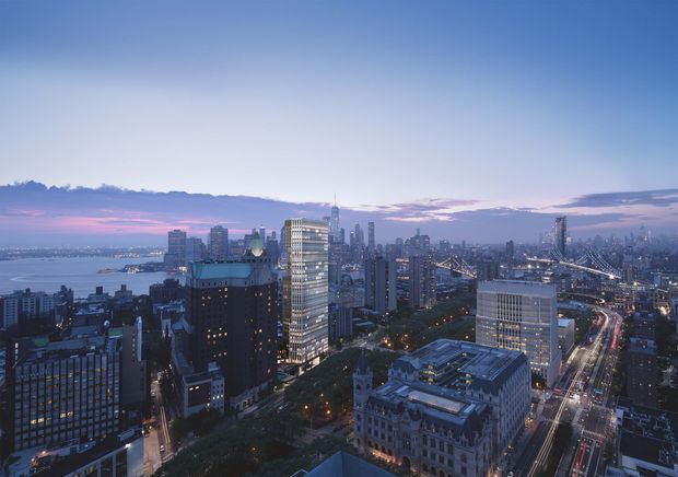 Elevated dusk view over a dense urban skyline, with high-rise commercial and residential buildings, illuminated streets, a waterfront at left, and a prominent suspension bridge extending across the right side. The image reads as a cityscape or architectural visualization rather than a specific interior space.