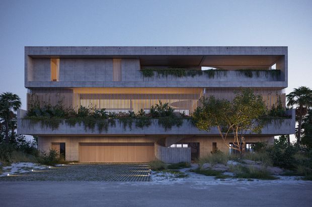 A contemporary multi-storey residential building viewed from the street at dusk. The facade uses large smooth concrete volumes, warm timber-clad or timber-screened areas, extensive horizontal openings, planted balcony edges, and integrated landscaping. A broad garage door and curved entry wall are visible at ground level, with palms and ornamental planting around the property.