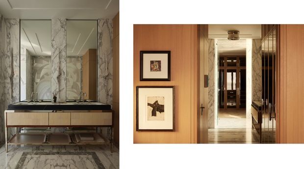 Composite interior image showing a refined bathroom vanity and a timber-panelled hallway or entry area. The bathroom features a double vanity with dark stone benchtop, pale timber cabinetry, large marble-look wall and floor surfaces, mirrored wall panels, and polished metal fittings. The adjacent view shows warm vertical timber wall panelling, framed artwork, timber doors, marble accents, and a long corridor leading toward another interior space. The overall look is luxurious, warm, and contemporary with strong natural-stone detailing.