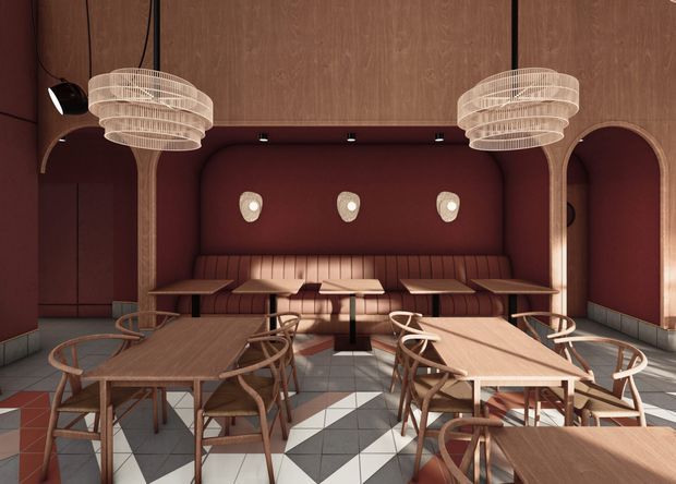 A richly styled hospitality dining area with multiple timber tables and curved wooden chairs arranged around a built-in banquette. The room features deep burgundy upholstered wall niches and seating, warm timber wall panelling and arched openings, sculptural layered pendant lights, and a striking geometric black-and-white tiled floor. The overall character is refined, warm, and theatrical.