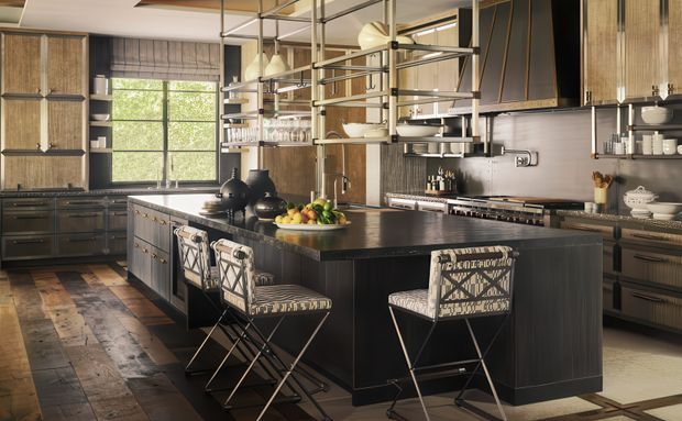 A spacious, refined kitchen centred around a large dark island with seating for four. The room features dark timber cabinetry, a black stone-look benchtop, open metal-and-glass shelving, exposed structural-style ceiling framing, pendant lights, patterned bar stools, and a mix of dark and light flooring. A large window brings in natural light, while integrated appliances and neatly arranged kitchenware complete the space.