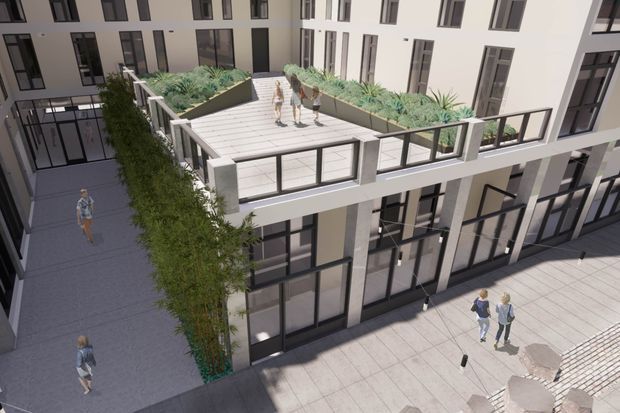 Architectural rendering of a multi-storey contemporary apartment or mixed-use building arranged around an internal courtyard. The image focuses on a raised communal terrace with planters, glass-and-metal balustrades, large dark-framed windows, and people using the surrounding pedestrian plaza and walkway.