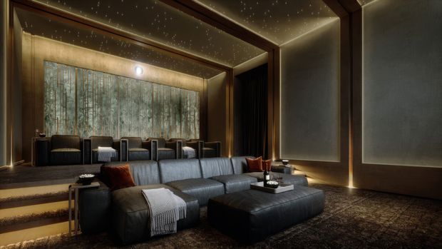 A luxurious, dark-toned media room with a large sectional sofa and ottoman facing out of frame, tiered carpeted seating steps, and a secondary row of lounge chairs. Warm integrated LED lighting outlines the wall and ceiling panels, which feature a subtle star-like pin-light effect. A large textured feature window or illuminated screen spans the rear wall, while bronze-brown wall finishes and deep carpeting create an intimate cinematic atmosphere.