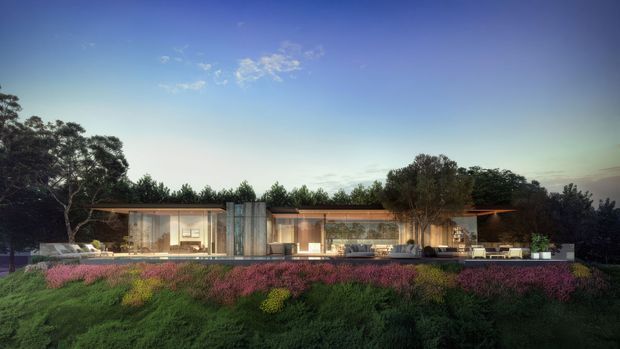 A wide architectural rendering of a low, single-storey contemporary residence set within a landscaped garden. The building has a long horizontal composition, extensive floor-to-ceiling glazing, warm timber-toned roof or soffit lines, pale solid wall elements, and broad outdoor terraces. Dense planting and mature trees surround the house, with the dusk sky providing a calm backdrop.