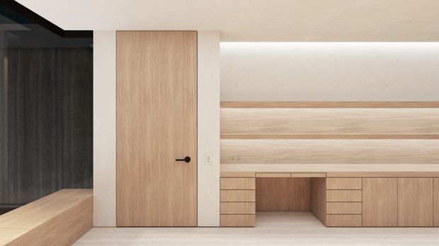 Minimalist built-in timber joinery wall with a flush light-wood door, low cabinetry, open shelving, and integrated horizontal wall panelling. A dark timber-lined niche and bench are visible at the left, creating contrast with the pale timber and off-white surfaces.