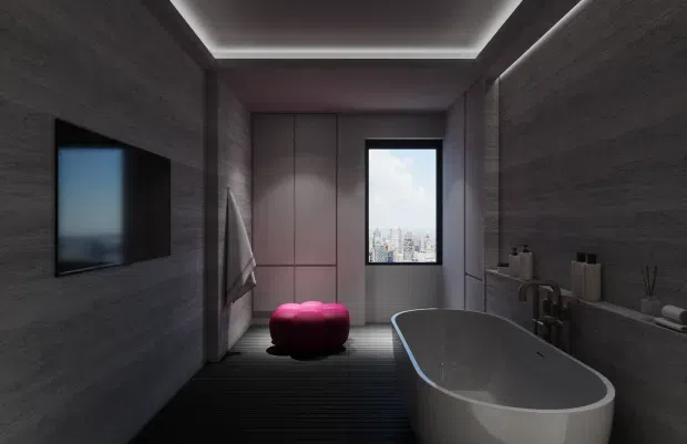 A dark, refined contemporary bathroom with a freestanding oval bathtub in the foreground, a wall-mounted television, integrated storage, recessed shelf styling, and a large window overlooking a city skyline. Charcoal textured wall finishes, dark linear flooring, concealed perimeter lighting, and a vivid magenta upholstered stool create a moody luxury atmosphere.