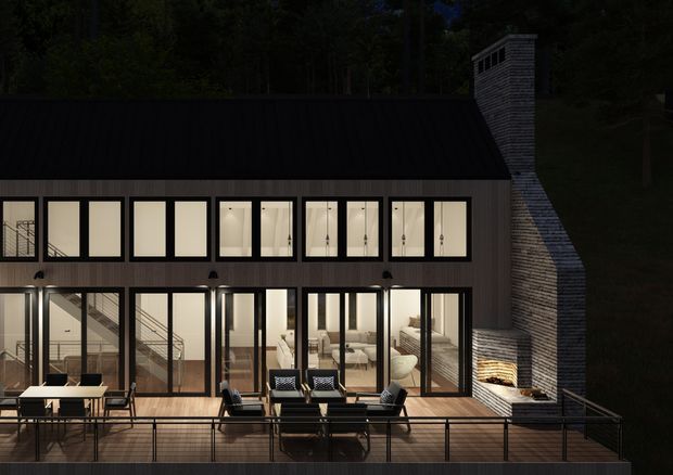 Night-time exterior architectural rendering of a multi-level contemporary house set against a wooded backdrop. The dark metal-clad facade has extensive floor-to-ceiling glazing, a broad timber deck with outdoor dining and lounge furniture, and a prominent tall masonry chimney with an outdoor fireplace.