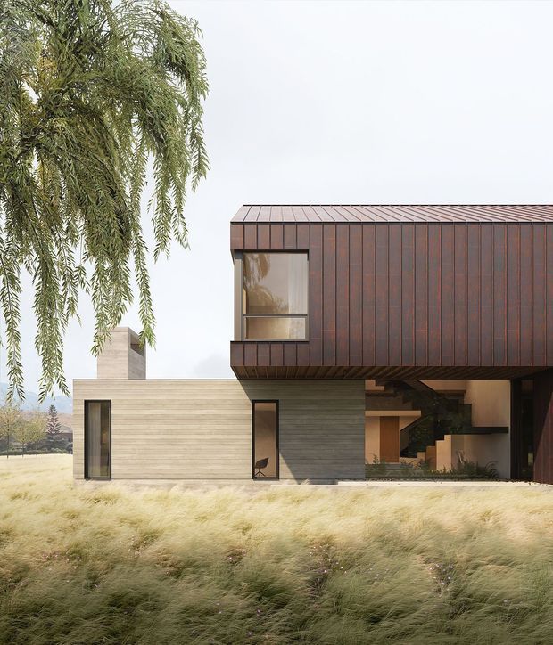 A contemporary two-storey house viewed from the landscaped exterior. The lower level combines pale horizontal cladding with large glazed openings, while the upper volume is clad in dark rust-brown vertical panels with a projecting box-like form. A covered opening reveals part of the interior, including a stair and warm-toned finishes. Tall ornamental grass and a drooping tree frame the minimalist residential facade.