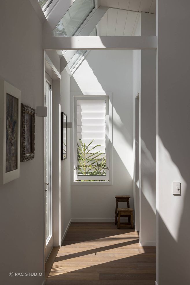 Raked clerestory windows invite light into the home