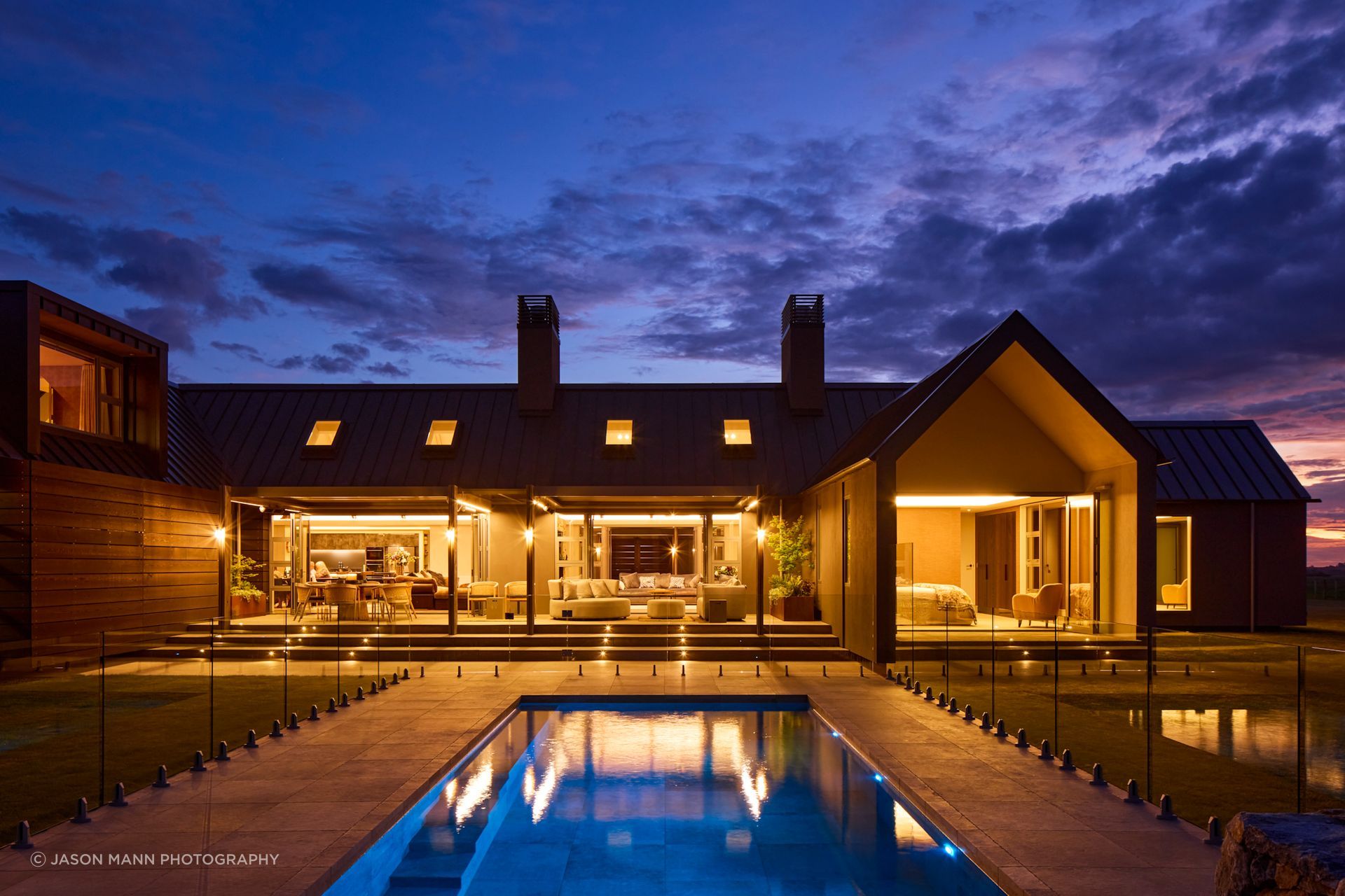 A view at night; the striking geometric shapes of the apertures cut slices of light into the form of the home.