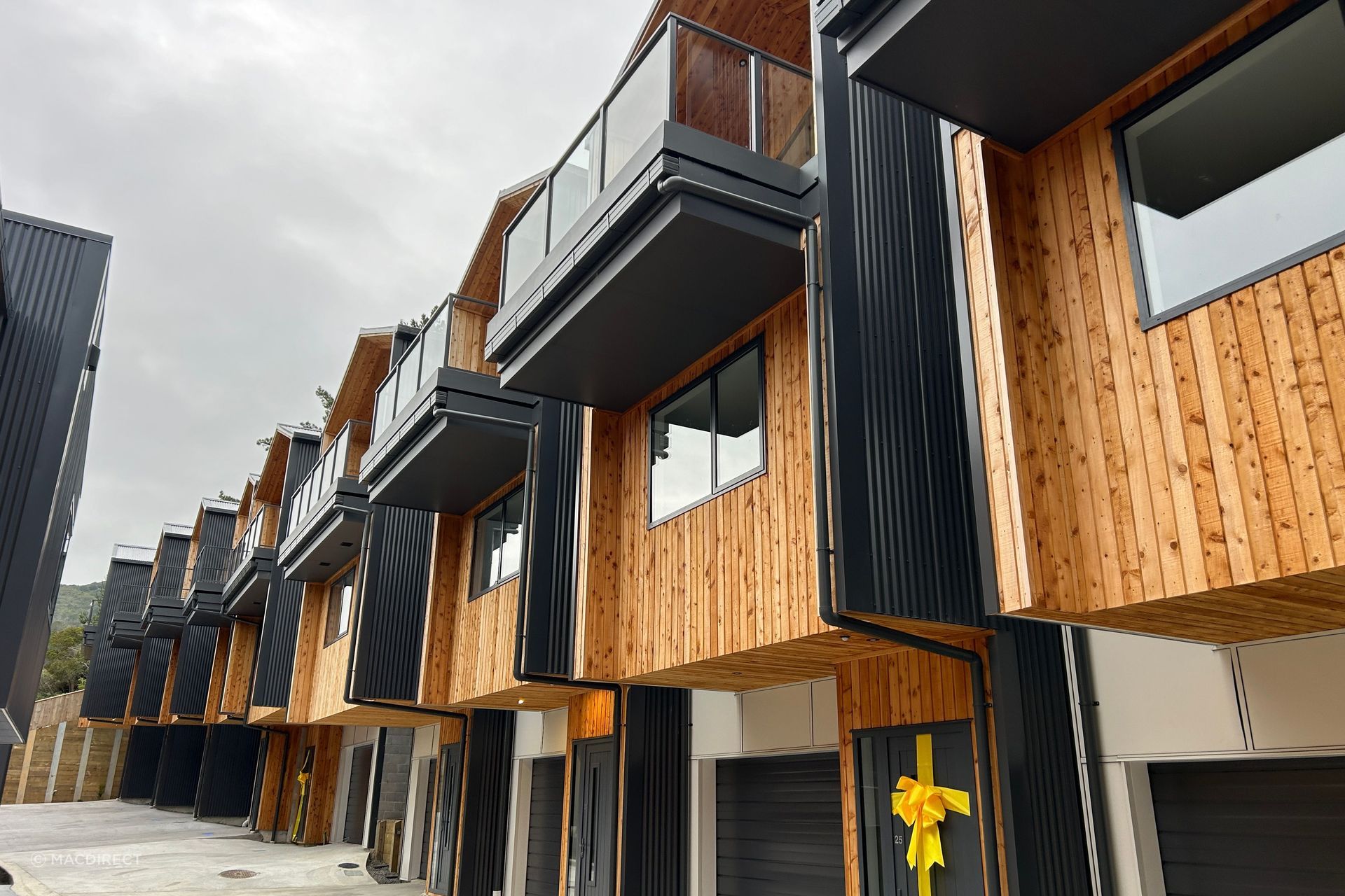 Extensive use of MacDirect's macrocarpa timber softens the exterior façade.