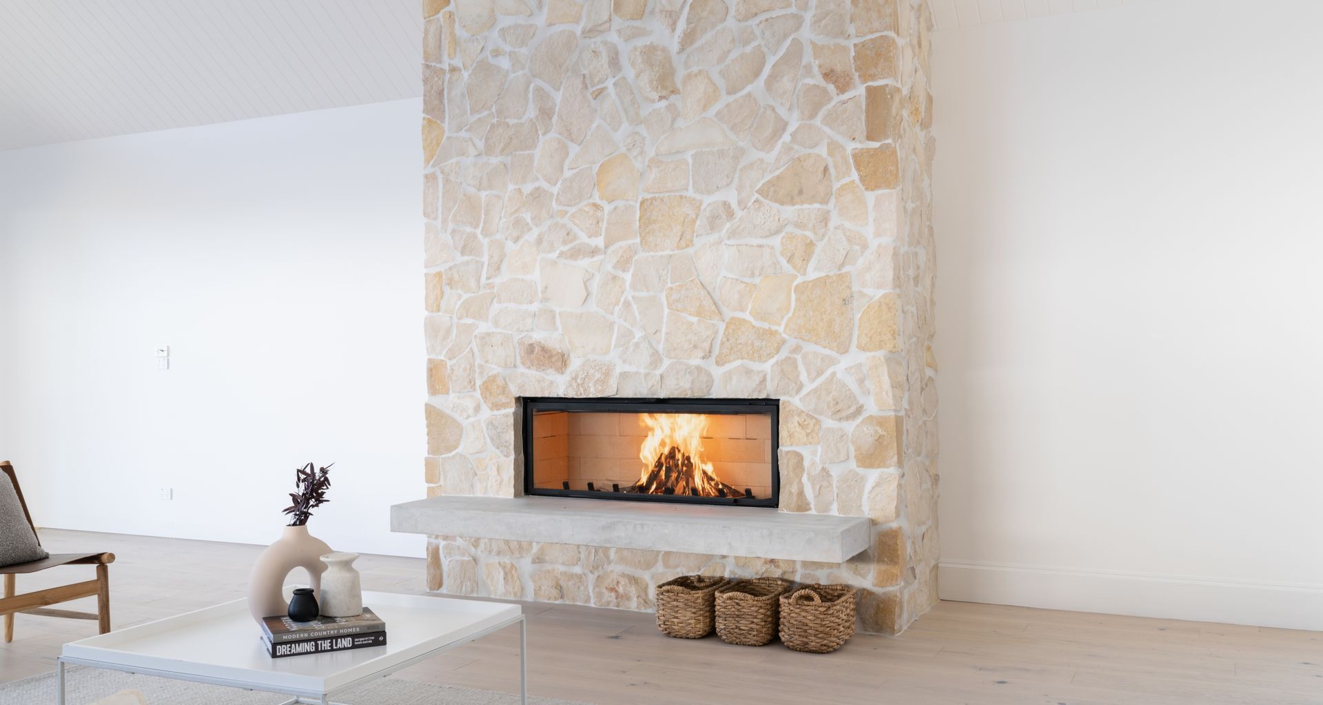 Axis H1600 featured in stacked stone wall from Sculpt Fireplace Collection.