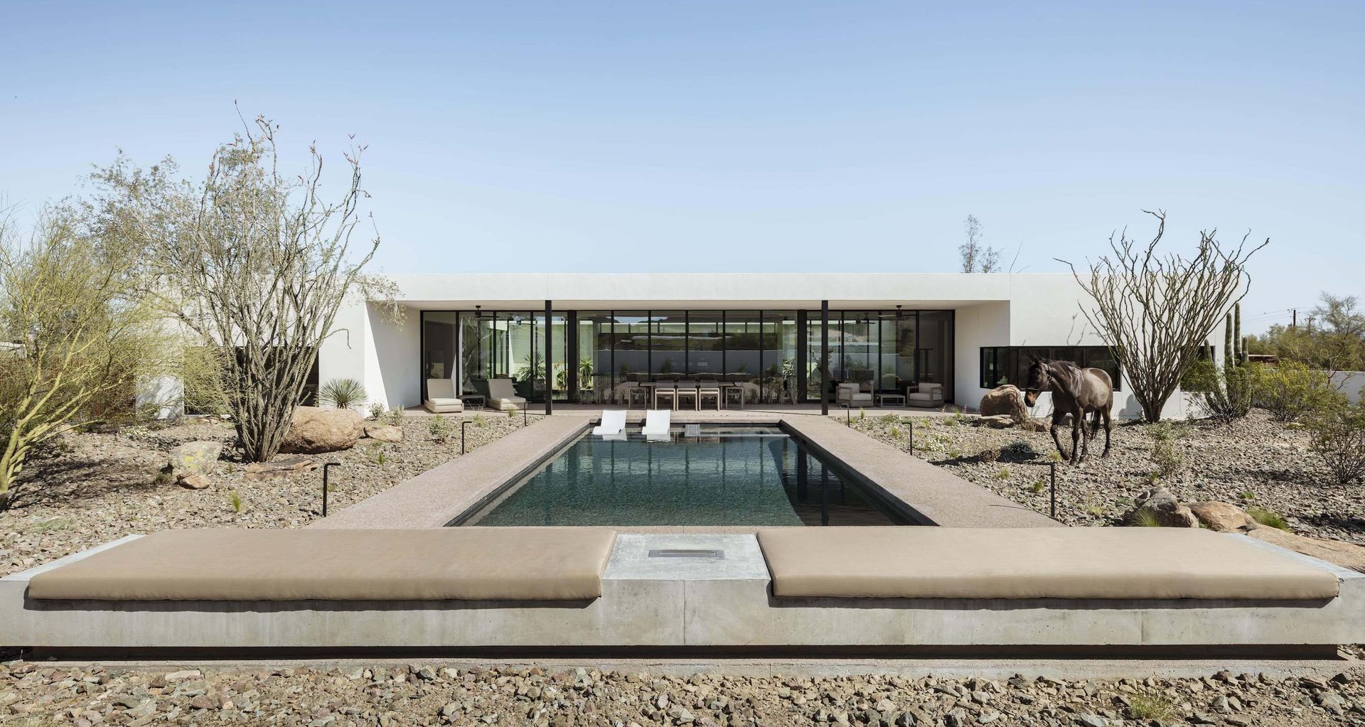Located in Phoenix, Arizona, and designed by The Ranch Mine, O-asis is a 12.5-foot-tall, solar-powered smart home organized around a central courtyard, a proven desert strategy that brings indirect daylight, cooler air, and seasonal views of desert planting.