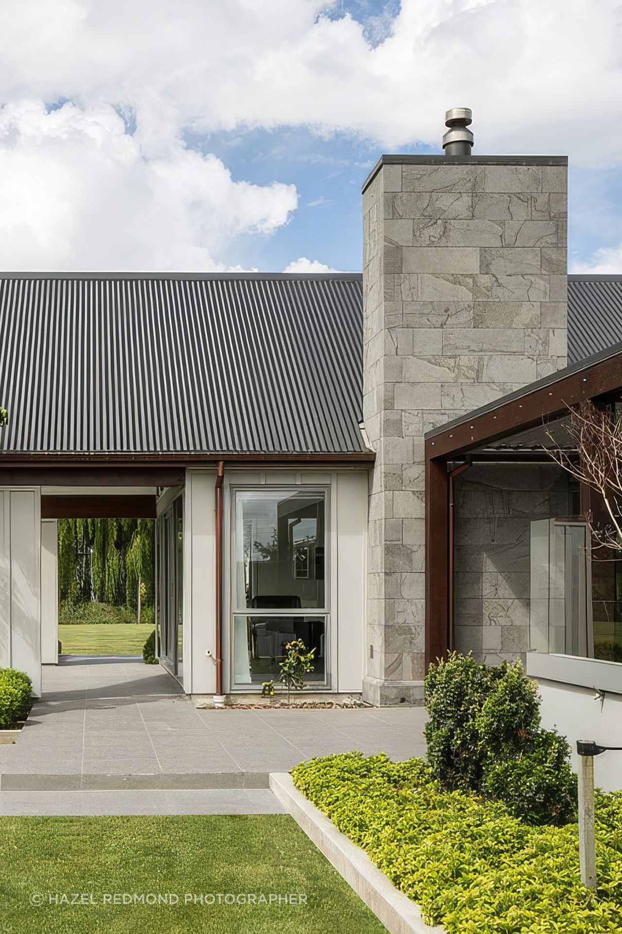 The soft grey of this lightweight bluestone cladding adds an inviting warmth to the façade.