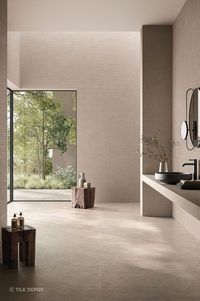 This bathroom has a handmade feel and features the Cement Vibes in Fango from The Tile Depot.