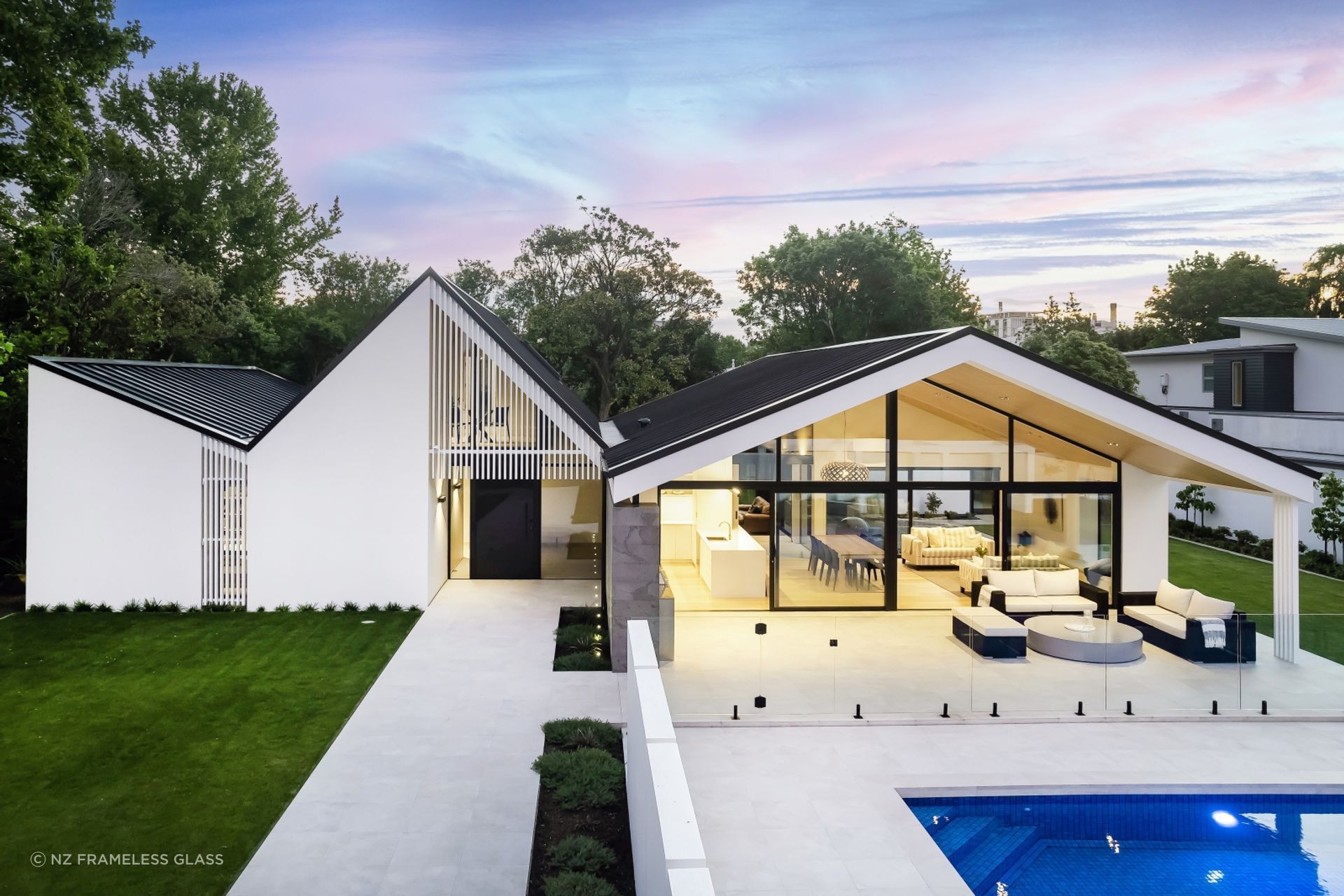 A stylish pool fence by NZ Frameless Glass showing how exquisite glass pool fences can be.