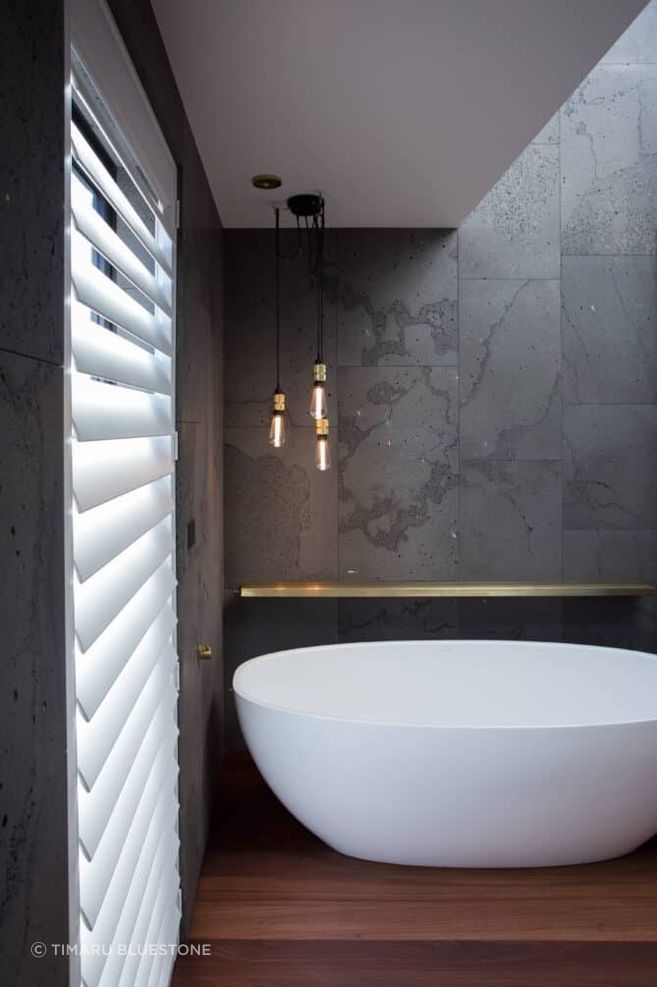 The natural veining of the bluestone tiles adds character to the bathrooms of this Pemberley home.