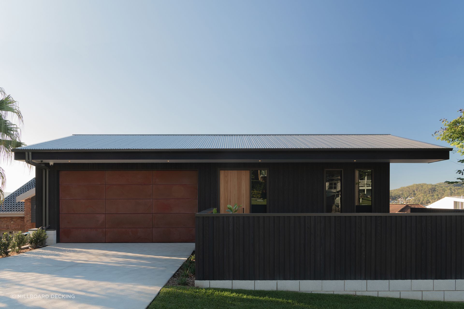 Millboard's Envello cladding in Burnt Cedar.