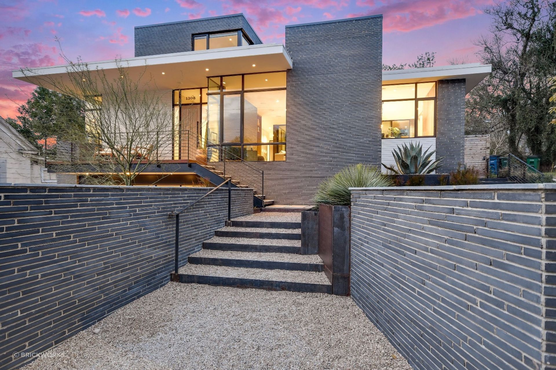 Dramatic proportions inherent in long-format bricks accentuate the linear feel of this walled entrance.