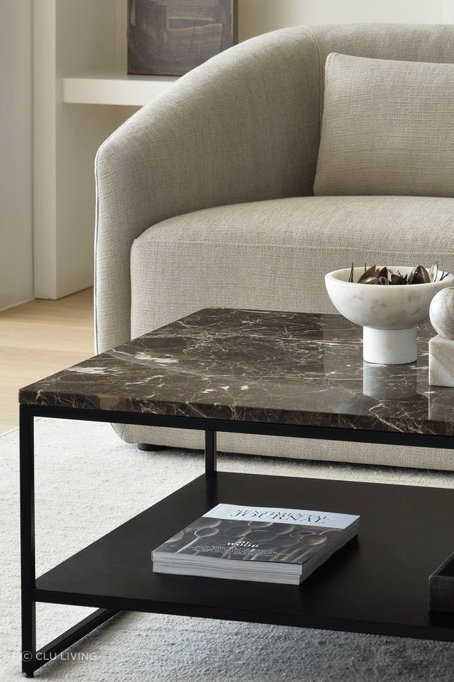 A polished marble coffee table stands as a statement piece in a living room.