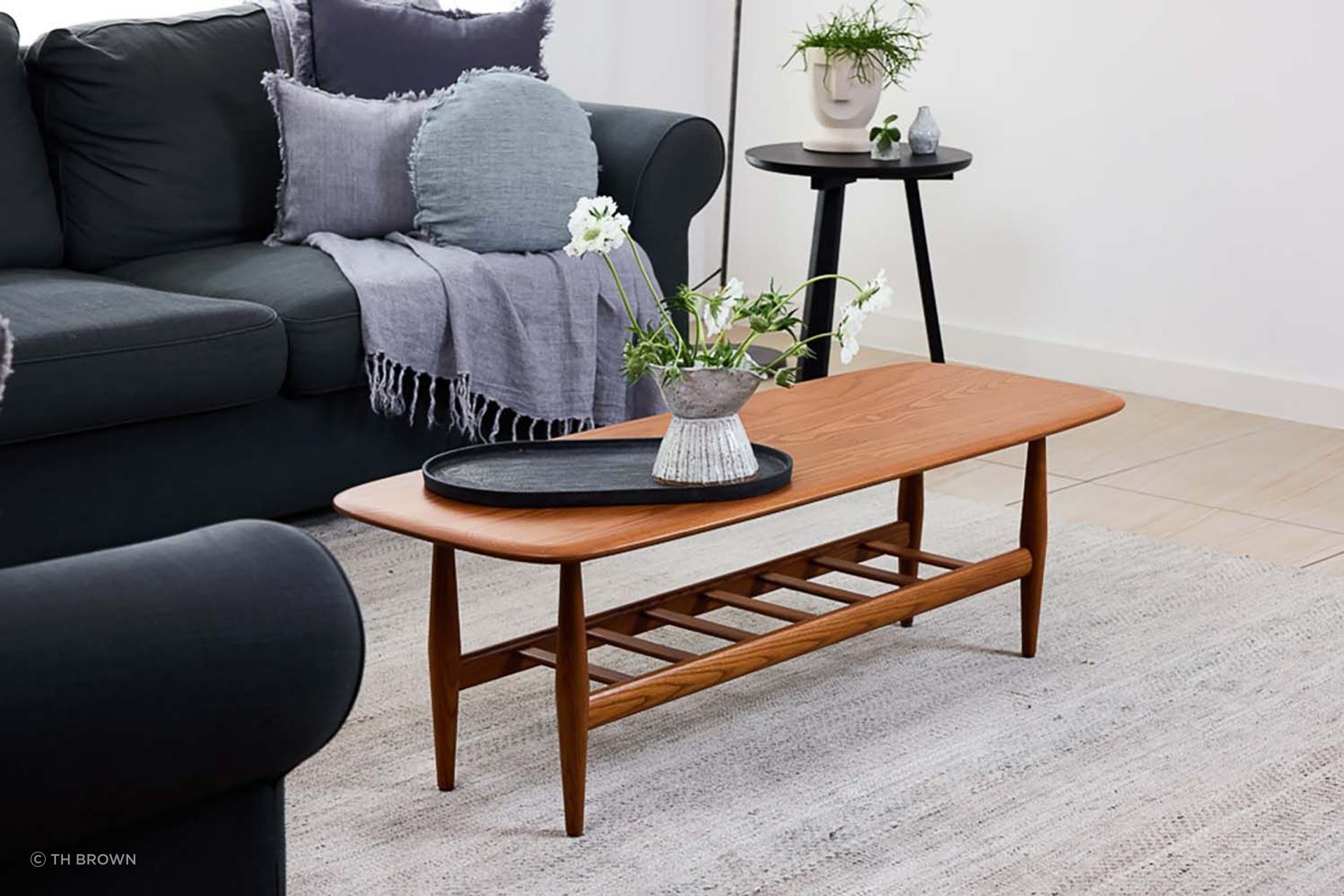 This solid dark ash coffee table boasts a convenient, functional magazine rack. Featured product: Frisco Coffee Table.