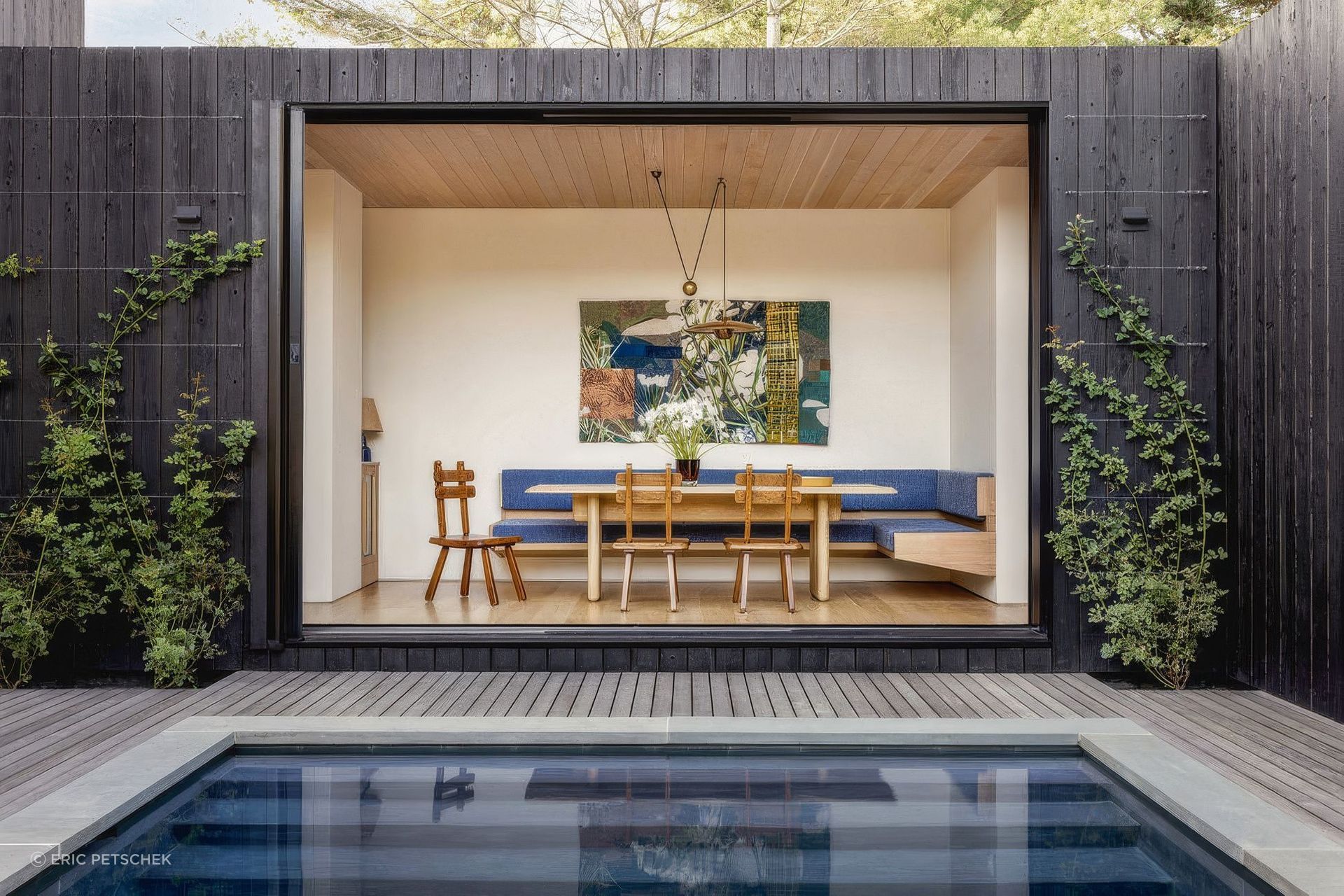 Designed for hosting friends and entertaining, this Emily Lindberg Design's project's site plan revolves around the central pool on an elevated deck. The interiors palette plays with bursts of summer sun yellow, pinks, and orange, with shades of sky blue and ocean teal threading a cooling storyline throughout. A playful art collection sets the tone of each room alongside custom furnishings that mingle with vintage pieces.