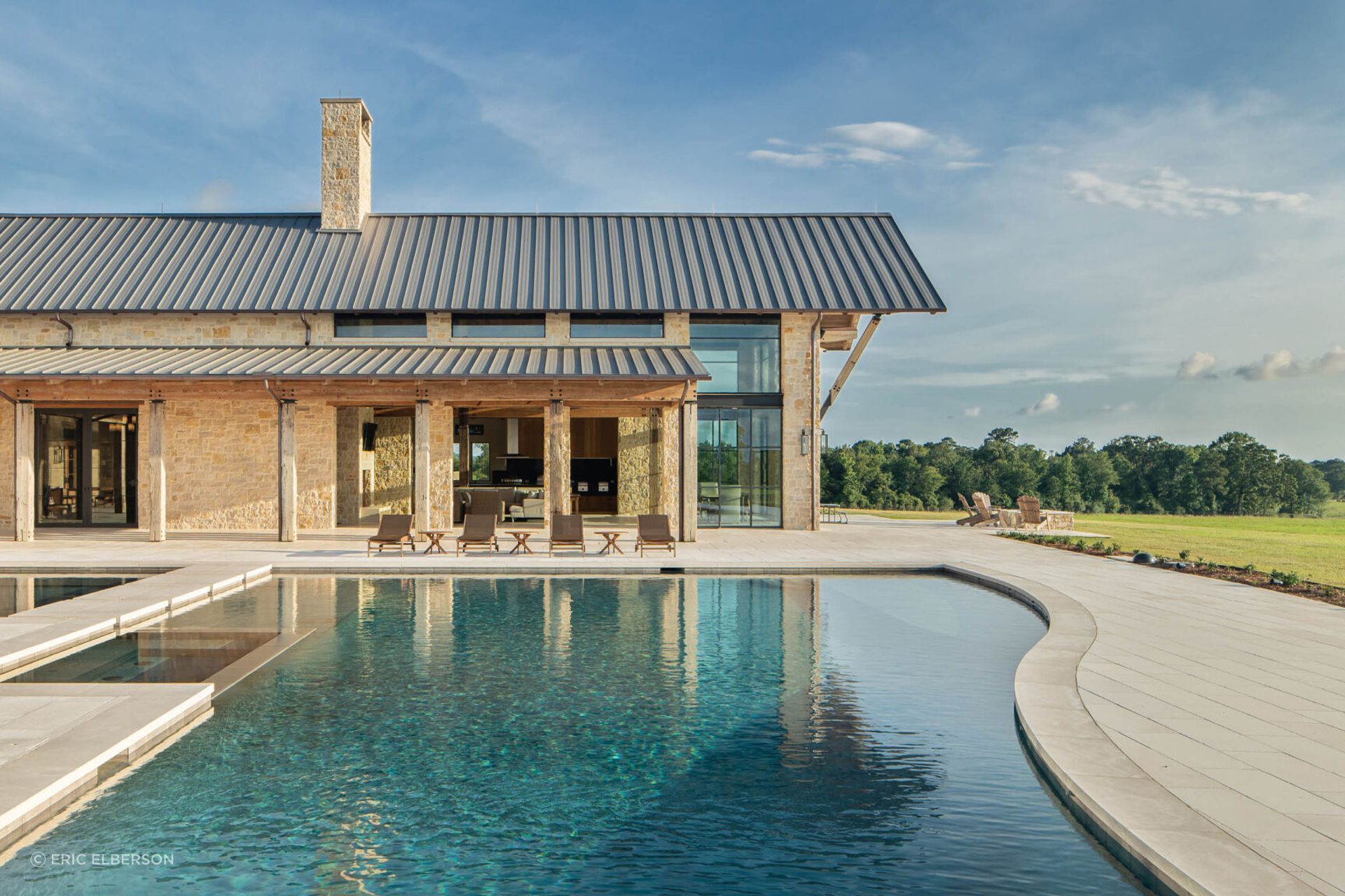 Situated on a cattle ranch, this Farmer Payne Architects's home features expansive architecture to compliment the vast surrounding scenery. Ample windows and outdoor spaces create a connection to the courtyard while private indoor spaces give the home a traditional lodge-like feel.