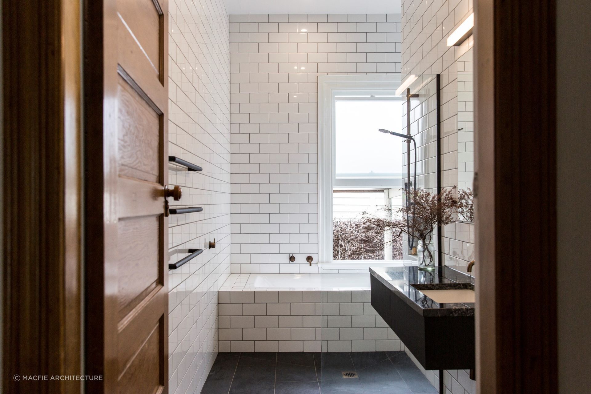 Beautiful tile details flowing seamlessly over the edge of the bath in this bathroom in Sandringham.