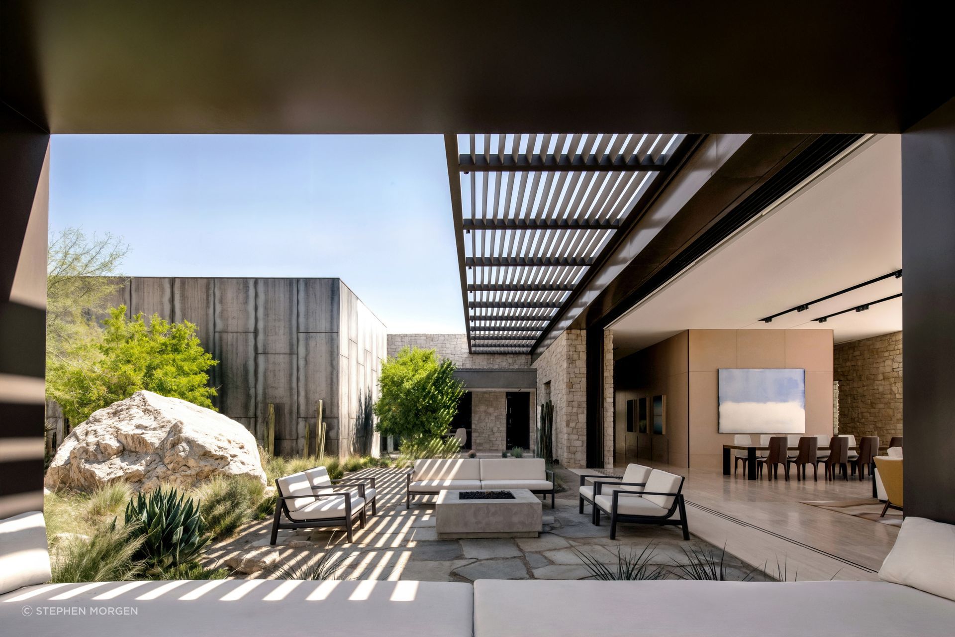 At Fort 137, deep roof overhangs and layered outdoor rooms temper the desert climate while extending daily living beyond the architectural enclosure.