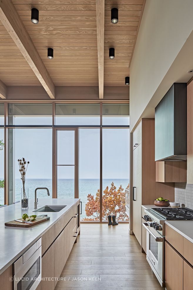 Stretching along the rugged shoreline of Lake Michigan, the layout of the Lower Shore Residence by Lucid Architecture is designed to maximize interaction between the home the water.