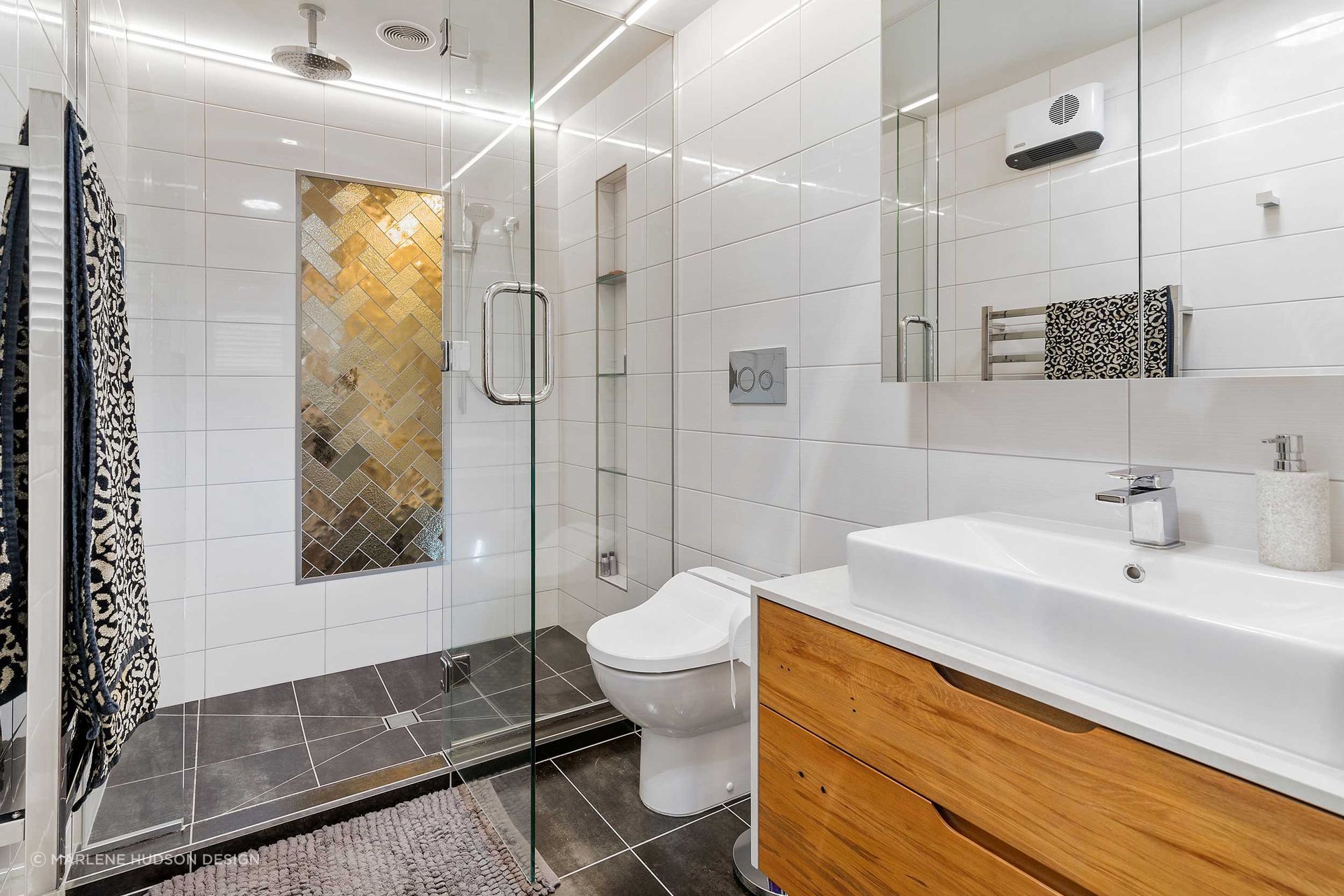 Bronze glass tiles bringing an artistic element to this Lynmore bathroom.