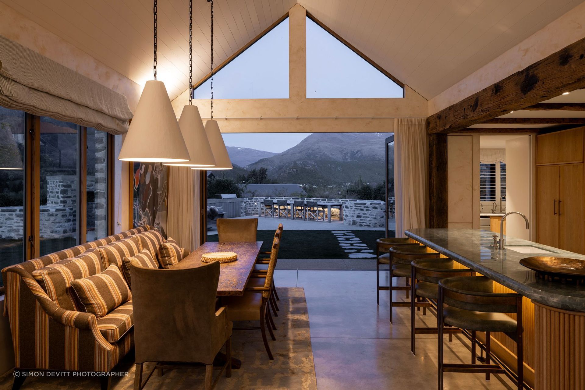 At Maihara Residence, material specification is inseparable from the way the home is lived in. Stone, timber, lighting and soft furnishings are composed around the rituals of cooking, gathering and retreat, creating a space that feels both highly resolved and deeply comfortable. Architecture: Mason & Wales Architects