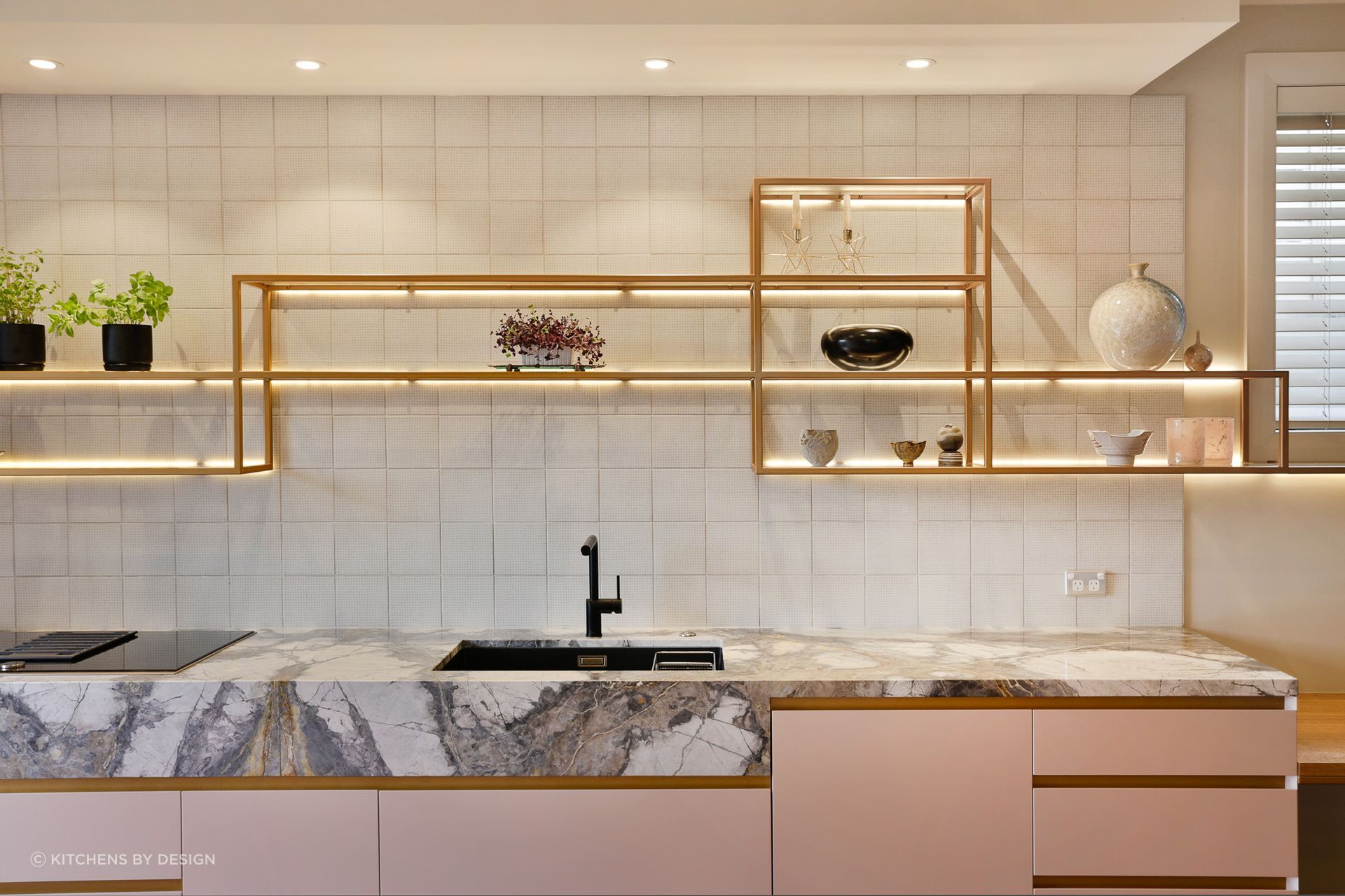 Square patterned tiles take centre stage in this immaculate kitchen in St Heliers.