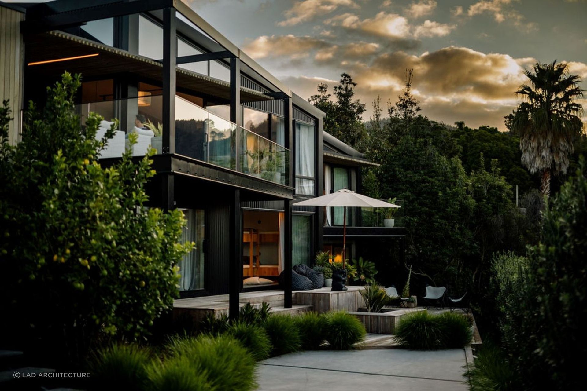 Balconies and decks adorned with pot plants and planters helps this home blend in with its natural surroundings. | Photography: Aaron Radford Photography