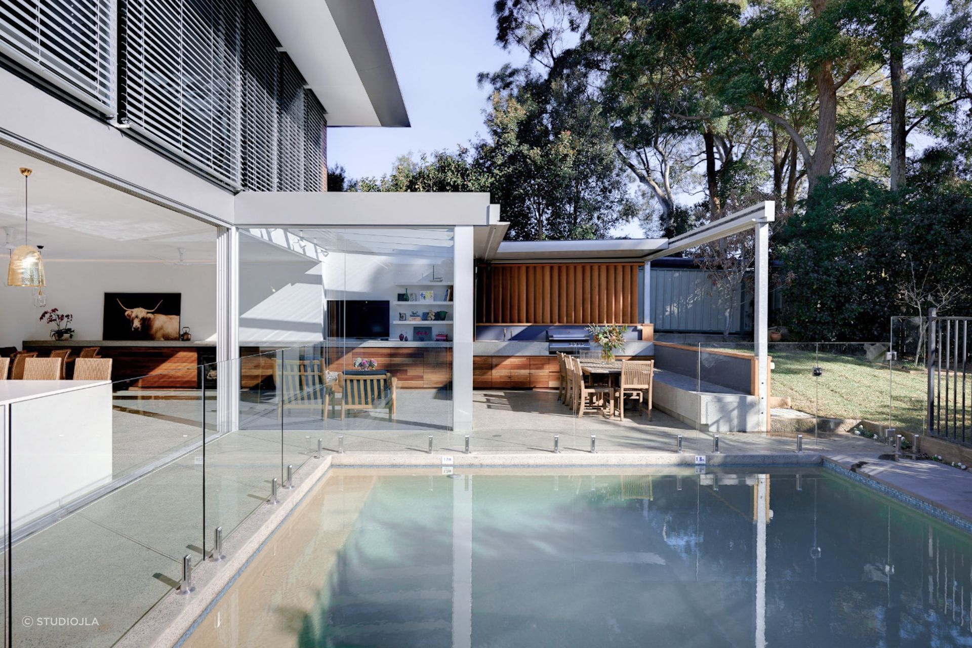 Pool landscaping doesn't always need to focus on plants and greenery, the right out door furniture and materials can lead the design. Featured project: Gladesville House - StudioJLA