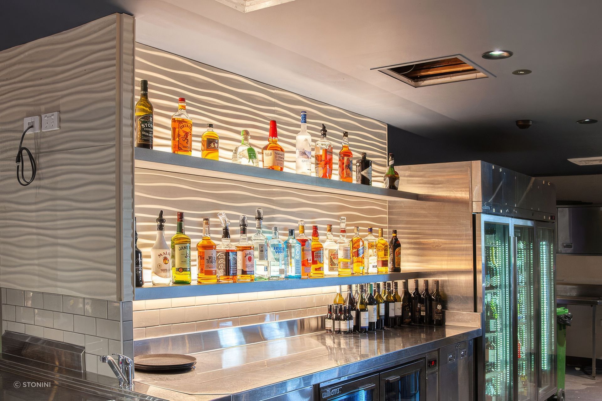 Stonini Rhythm panels provide a textured backdrop that accentuates the play of light and shadow created by the uplights.
