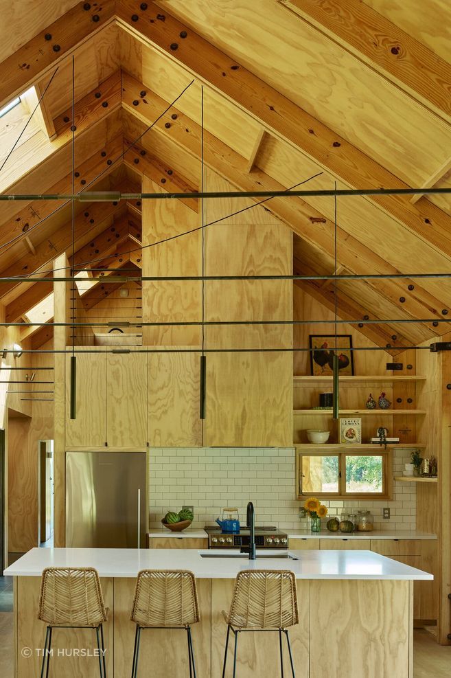 The kitchen has simple plywood cabinets, finished with a clear coat.