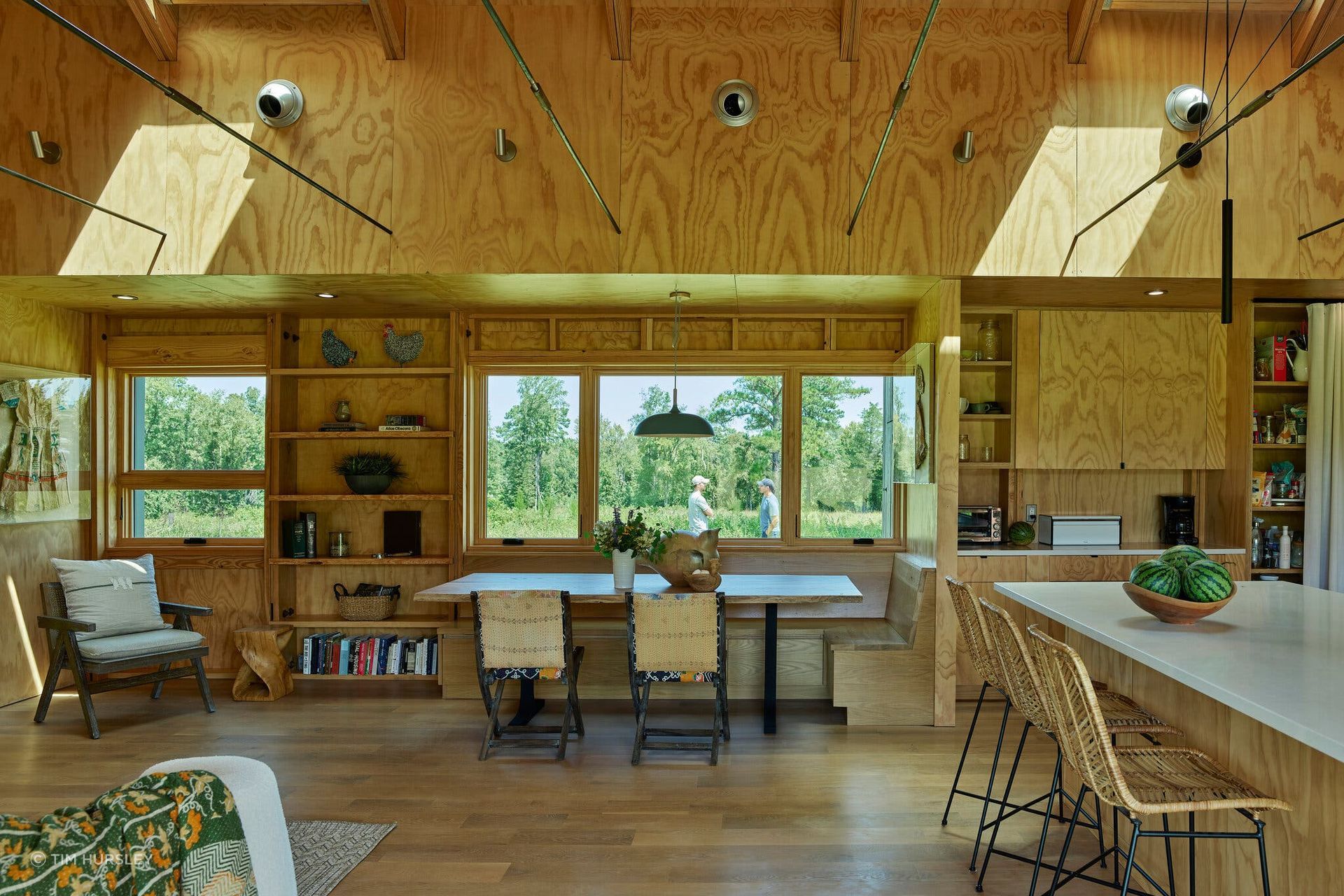 The center of the house is a do-it-all kitchen, living and dining space with a built-in banquette.