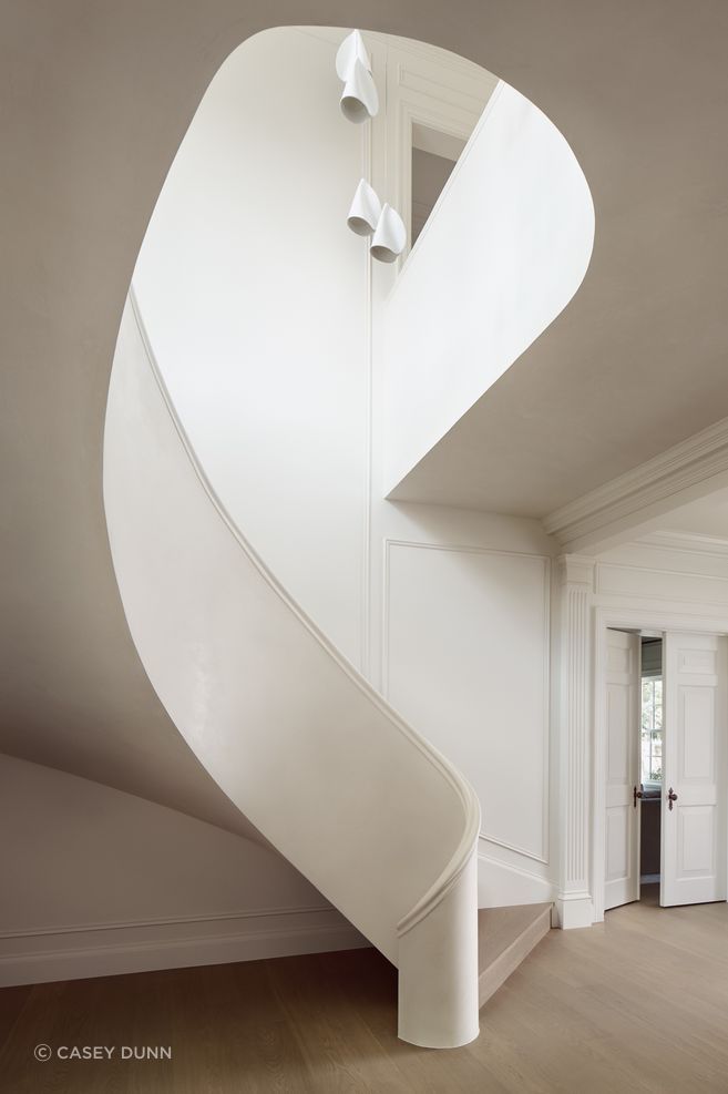 In the West Lynn Residence, a new helical stair stands as a modern homage to the non-salvageable original feature.