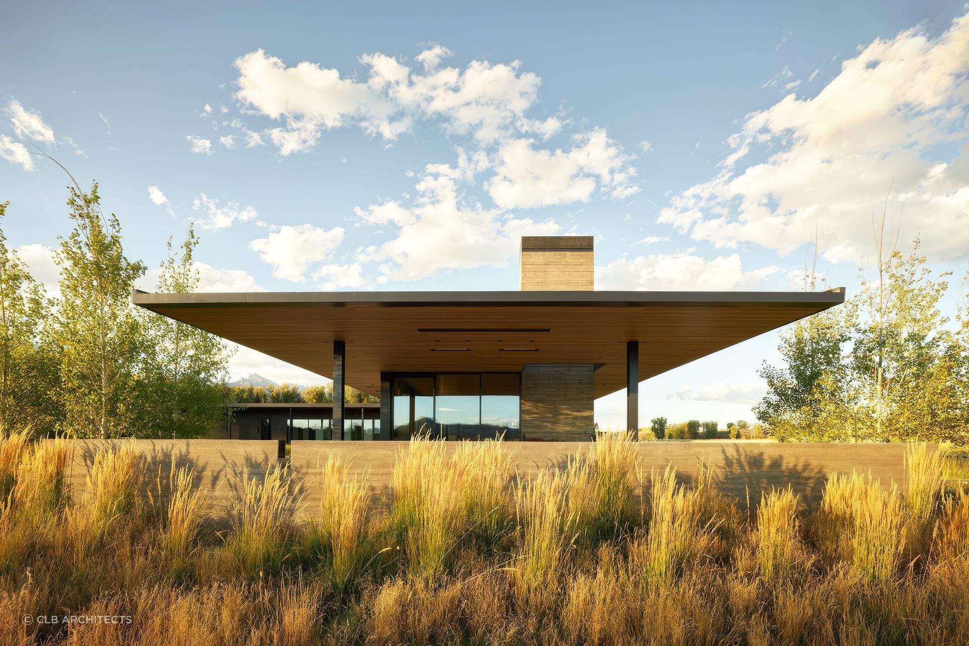 At Black Fox Ranch, the long, low slope of the roof is structured with a cross-laminated timber (CLT) roof system. The deep overhang creates cover for an outdoor dining terrace that frames Teton Mountain views to the west and the Gros Ventre Range to the east.
