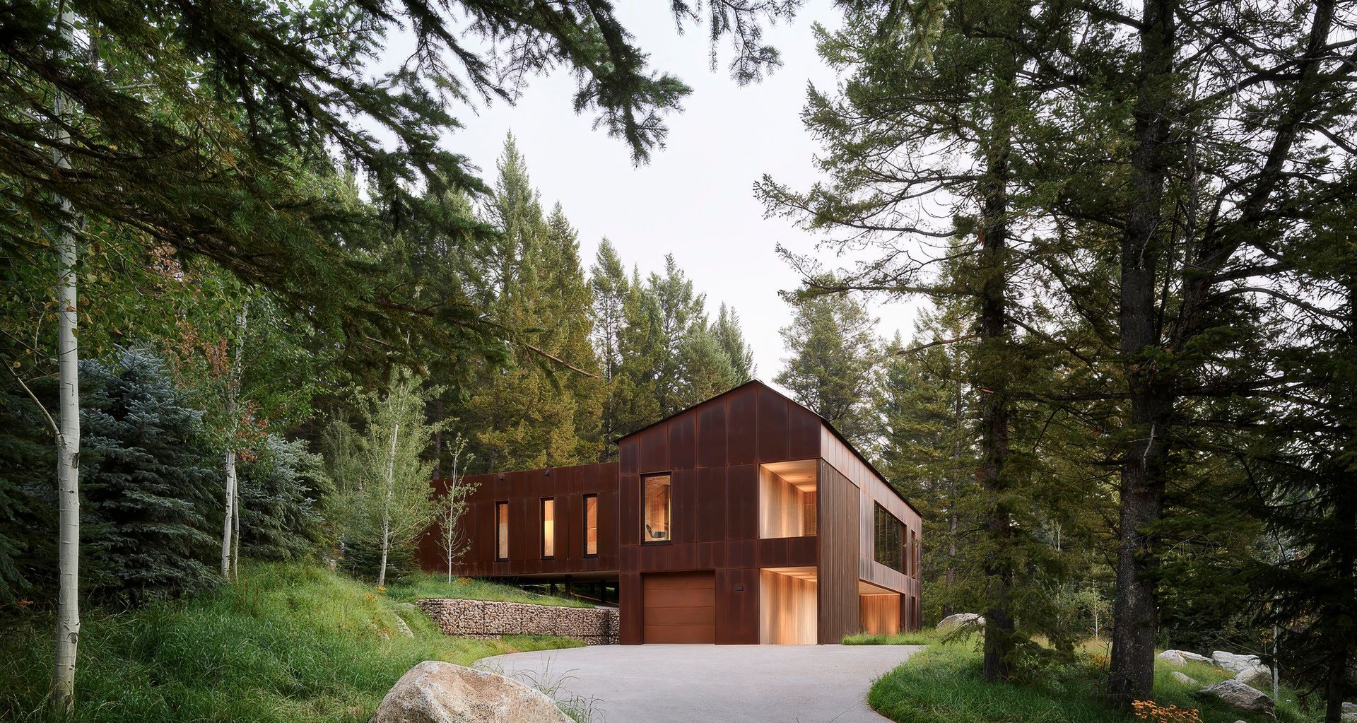 Located on one of the last undeveloped parcels in Teton Village, the site is defined by dense timber, rugged topography, and striking views of the Snake River Valley and surrounding peaks. The heavily wooded and boulder-strewn lot required a sensitive design approach, minimizing tree removal and site disturbance. Photo by Matthew Millman