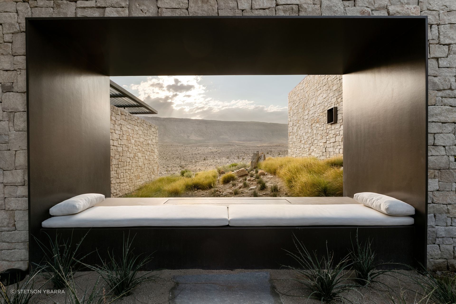 A precisely framed aperture captures the surrounding landscape, treating the desert itself as the home's primary work of art.
