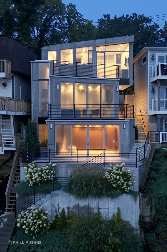 Narofsky Architecture's client desired to build a structure which cooperated with the east-facing slope, respected the adjacent homes (ones as close as 5 feet), and maximized the views of Manhasset Bay.