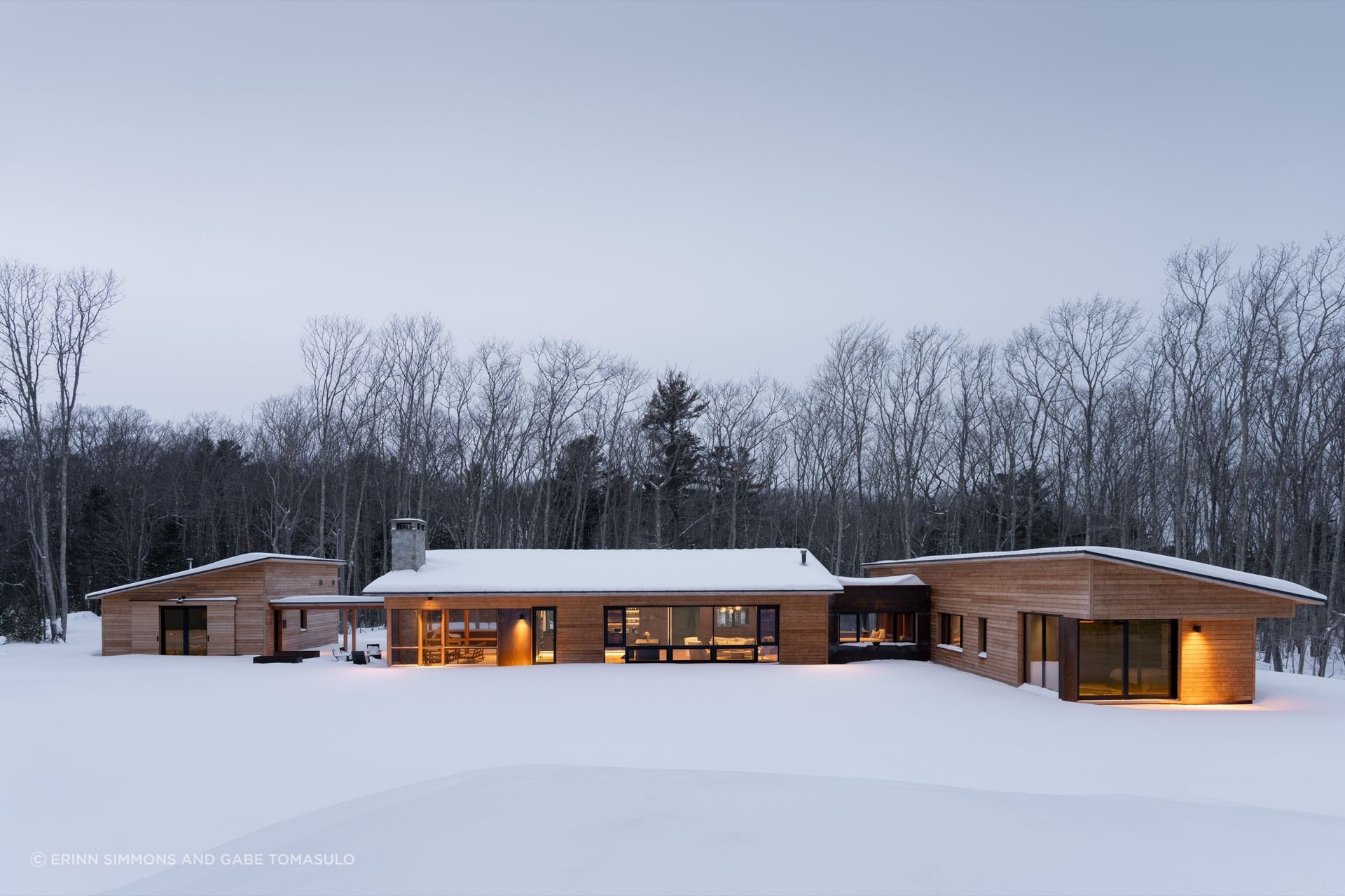 This home tucks into a clearing in the woods and is based on a simple organizing idea of spaces linked by clear axes of circulation so that moving through the home creates multiple opportunities to reconnect with the site.