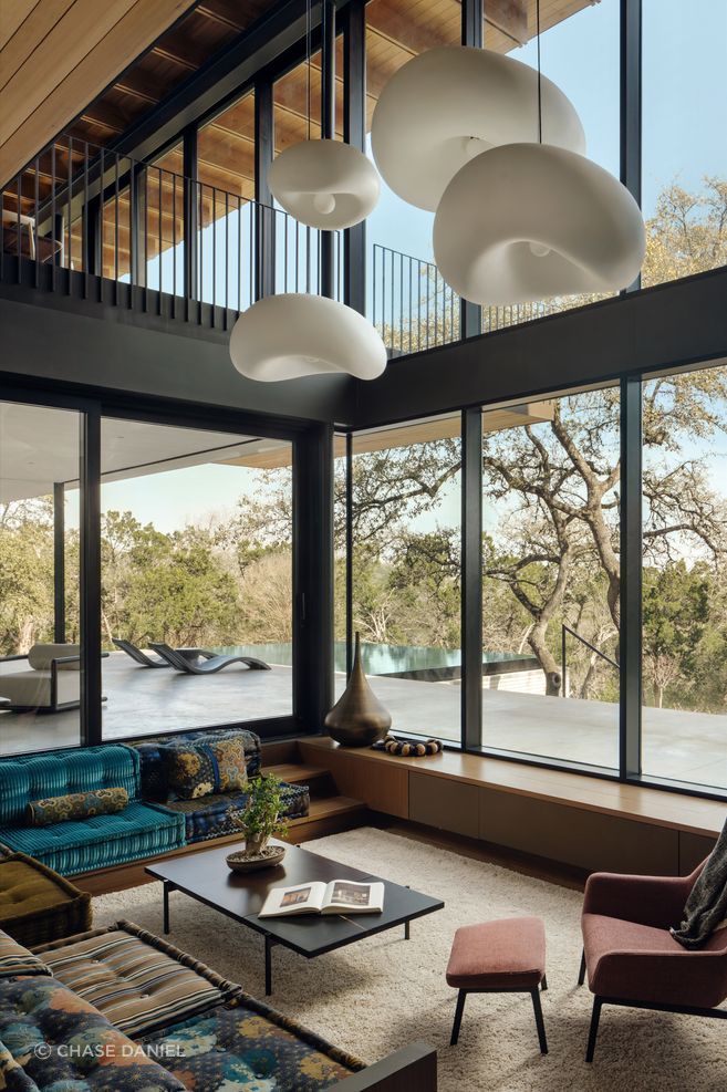 In Terrace Mountain, the Japanese influence shows up throughout in specific, considered choices: a sunken hearth in place of a conventional fireplace, imported Japanese tile, bonsai trees inside the living room, and a raking garden the client wanted to physically descend into and inhabit rather than simply view from a window.