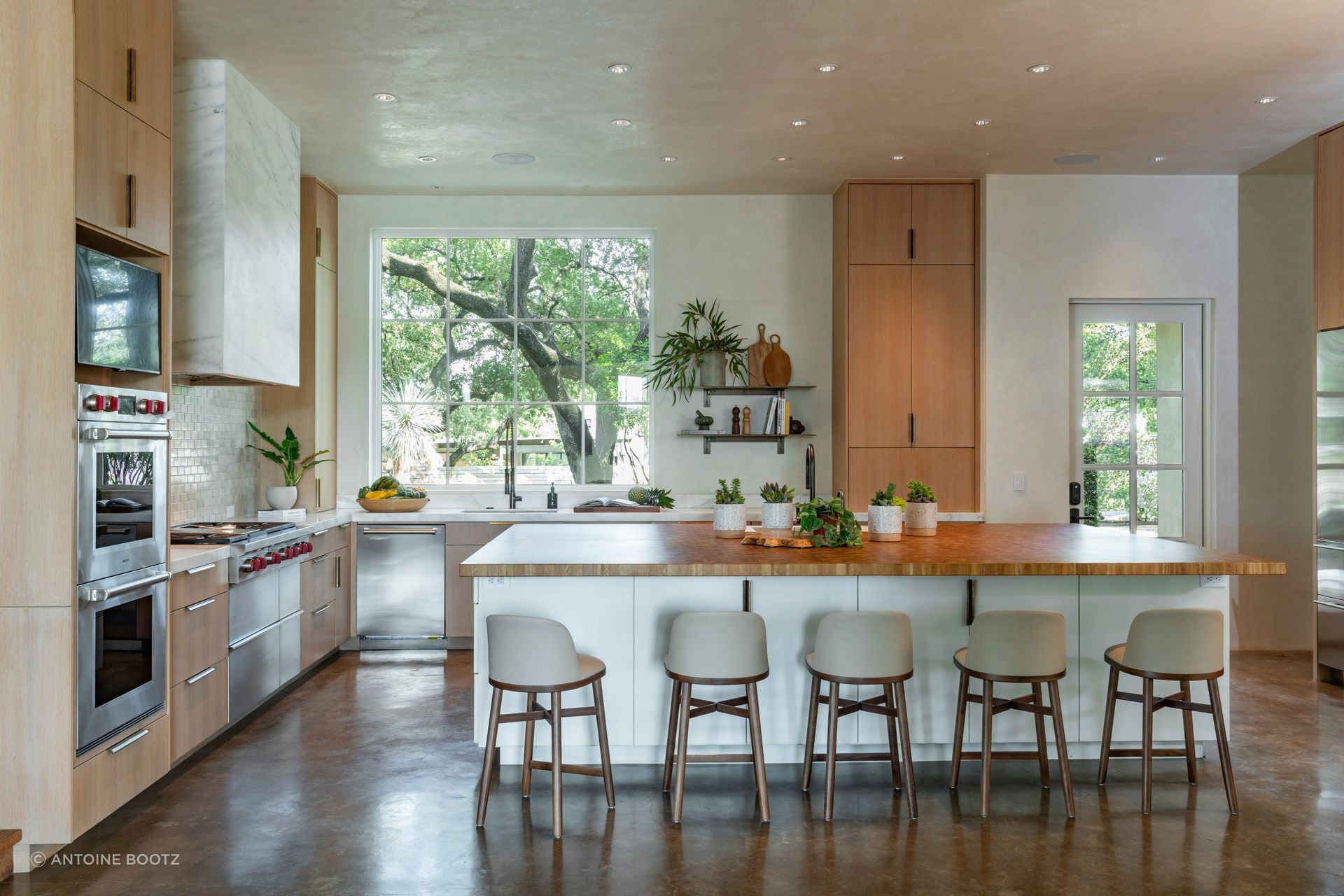 The kitchen island is made of end grain white oak and built by Adrienne Romine of Half Halt Studio in Austin.