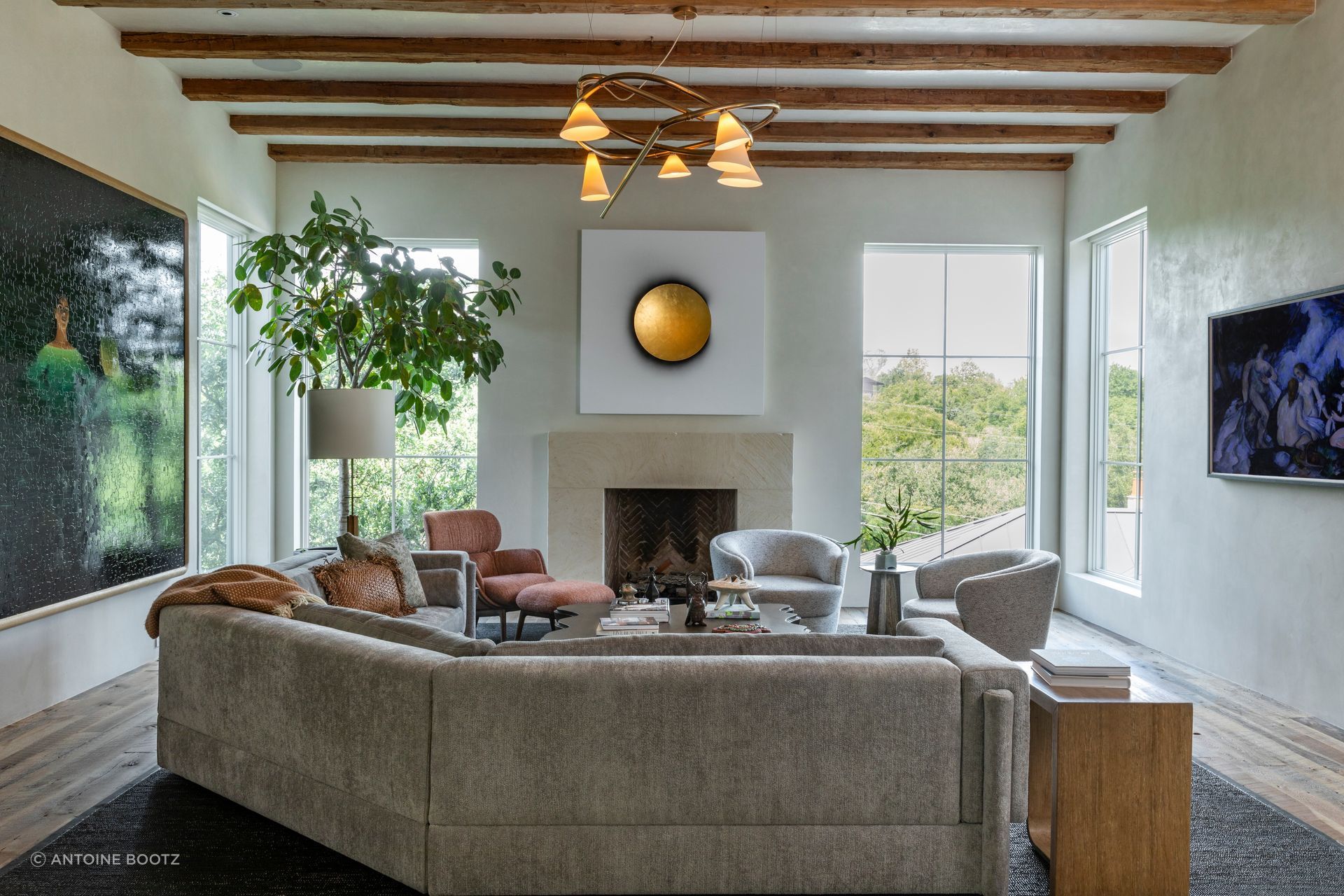 In the living room, the solar painting is by Lita Albuquerque and the chandelier is by Anna Karlin.