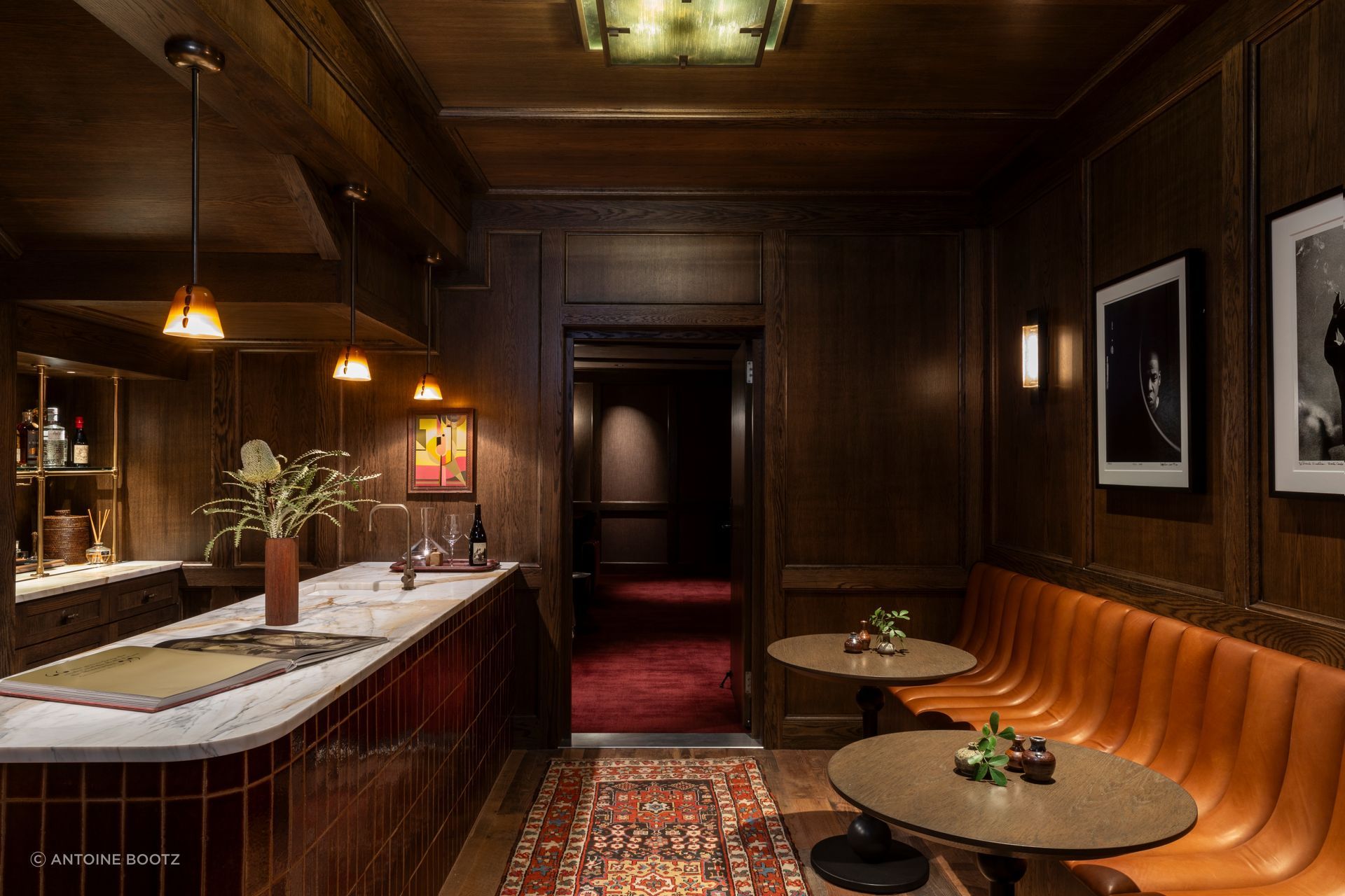 The house’s real departure sits below grade in what had been an unused basement space: a connected home theater and speakeasy, deliberately unmoored from the rest of the house’s material language. “It’s almost like you’re in a hotel and you go to the bar,” Cravotta says. “You’re sort of entering a new world. It doesn’t have to be cohesive with the rest of the house, yet it still feels like it belongs.”
