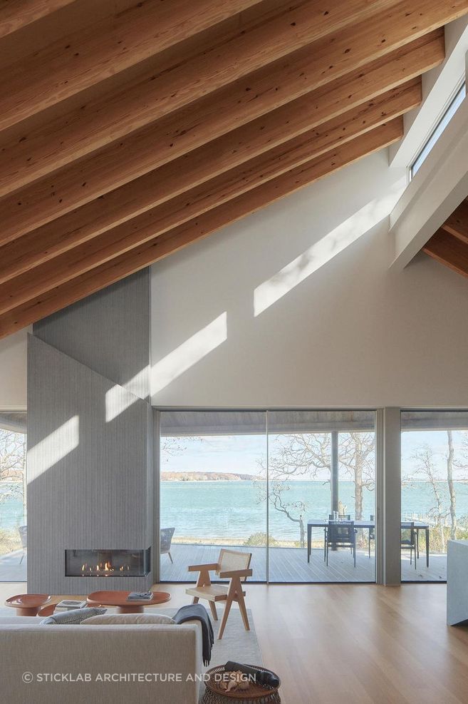 Structural Douglas fir roof beams and cypress wood wall planks—finished with a flamed shou sugi ban treatment—embrace the living areas with warm tones and textures. A south-facing clerestory along the roof ridge allows sunlight to wash into the living spaces throughout the year.