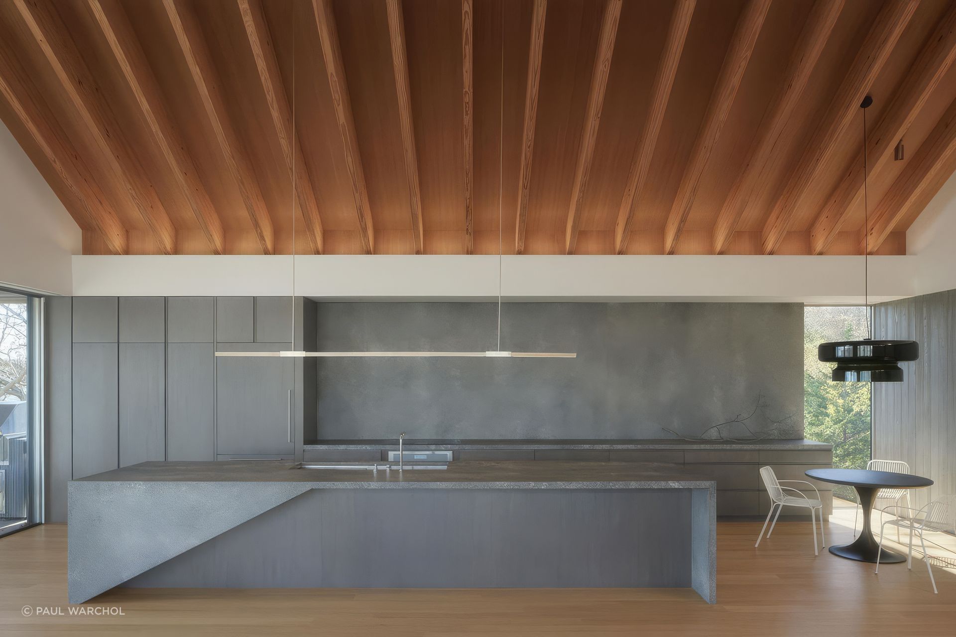 “The kitchen includes a sculptural island whose form references the angles of the nautical pennants adorning the sailboats passing by,” Chia says.